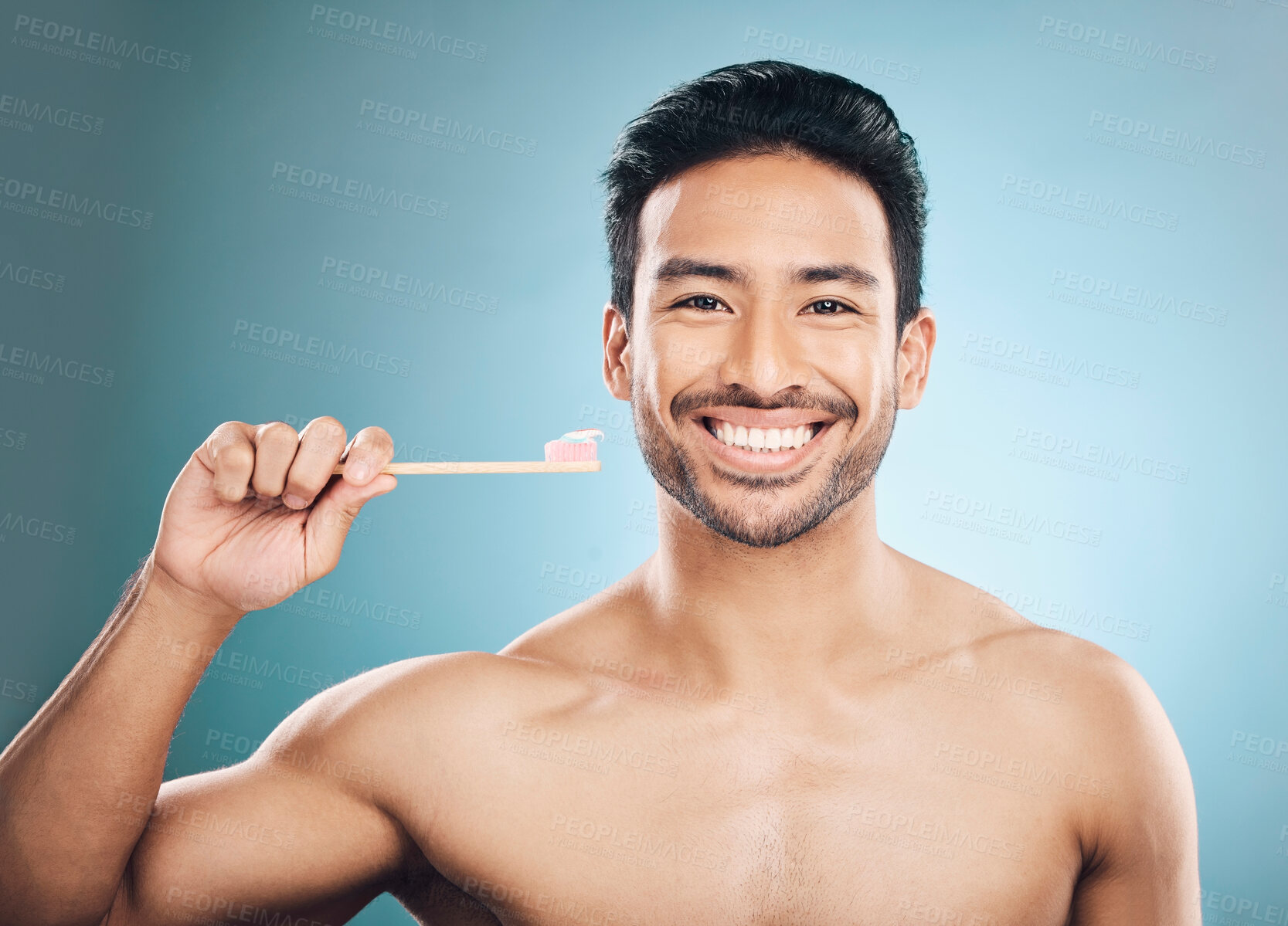 Buy stock photo Dental, portrait and Asian man with a toothbrush, oral hygiene and wellness against a blue studio background. Face, male person and happy model teeth cleaning product, toothpaste and fresh breath