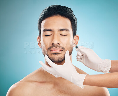 Face, hands and transformation with a plastic surgery man in studio on a blue background for beauty enhancement. Aesthetic, botox or prp with a young male patient eyes closed in a clinic for skincare