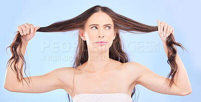Buy stock photo Thinking, woman and damaged hair in studio with cosmetics, haircare or confused face for beauty, problem or split ends. Frustrated, girl and ideas for hairstyle in salon or growth on blue background