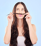 Hair, moustache and woman in studio for beauty, salon aesthetic or healthy shampoo on blue background. Haircare, face and funny female model with strand of natural waves, texture or keratin cosmetics