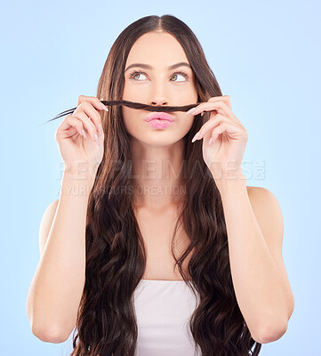 Buy stock photo Hair, moustache and woman in studio for beauty, salon aesthetic or healthy shampoo on blue background. Haircare, face and funny female model with strand of natural waves, texture or keratin cosmetics