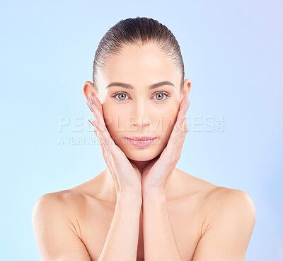 Buy stock photo Portrait, woman and touch face in studio for skincare, aesthetic shine and natural dermatology on blue background. Female model, beauty and feeling soft facial results, glow and healthy spa cosmetics