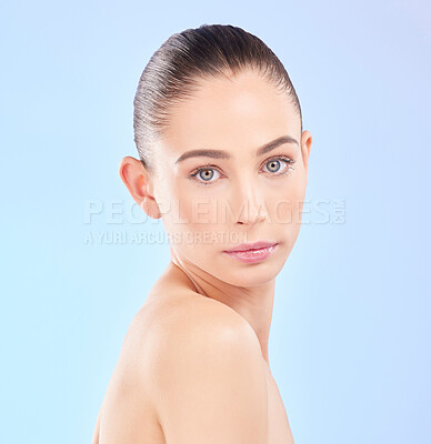 Buy stock photo Portrait, serious woman and natural skincare in studio, healthy aesthetic glow and facial dermatology on blue background. Face of young female model with beauty, clean cosmetics and wellness of shine