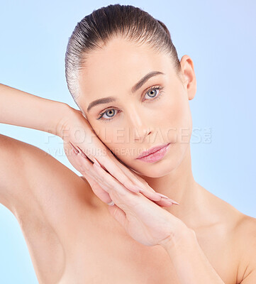 Buy stock photo Face on hands, beauty and woman, natural and cosmetics with skincare isolated on blue background. Female model, healthy glow and clean skin, dermatology and portrait with spa facial in a studio