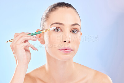 Buy stock photo Makeup, portrait and woman with brush on eyes on blue background for cosmetics and skincare. Mascara tools, eyelash and natural beauty, face of model with eye product application on lashes in studio.