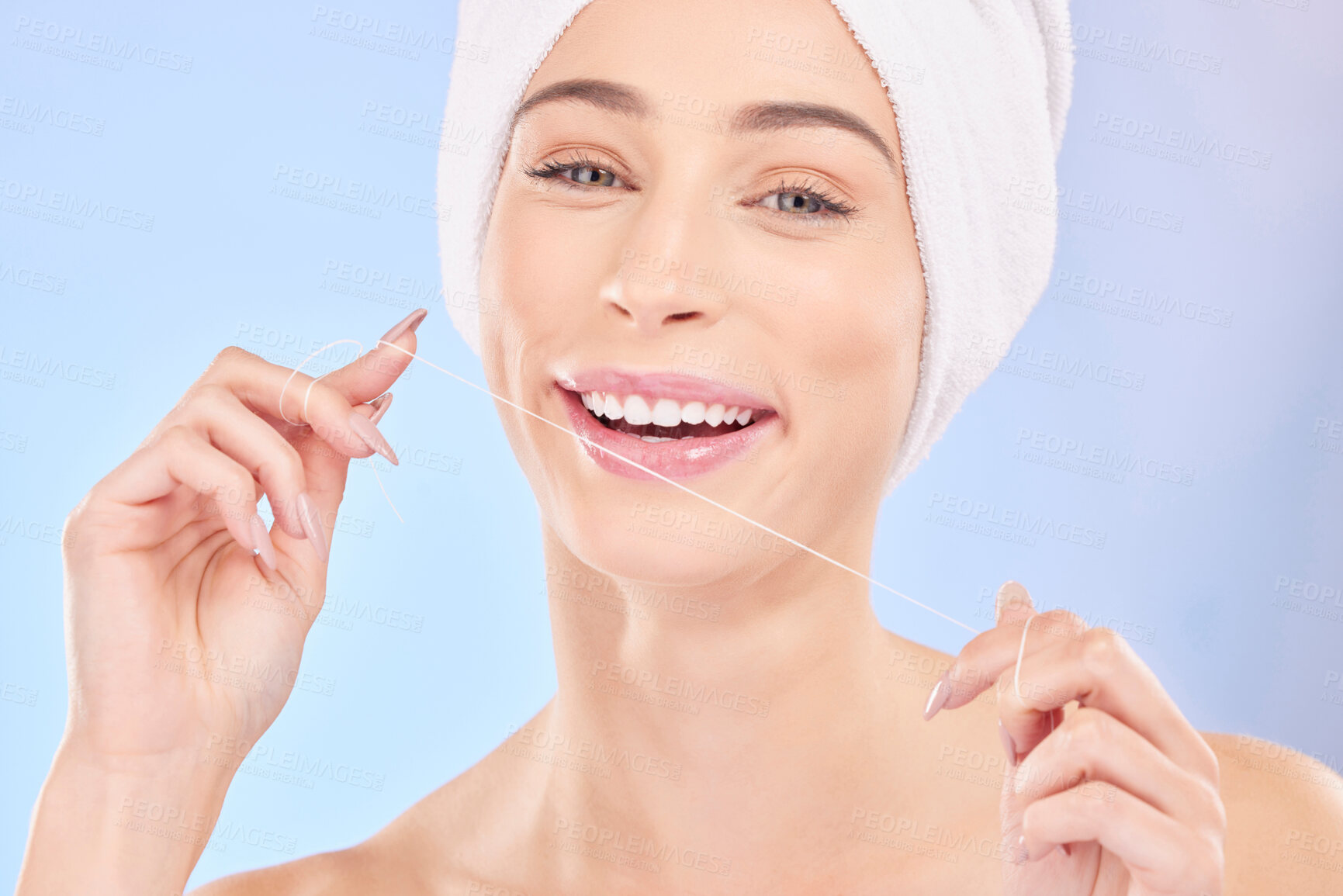 Buy stock photo Flossing, teeth and woman in portrait, dental and health with oral care isolated on blue background. Female model, morning routine and orthodontics, hygiene and cleaning mouth with thread in studio