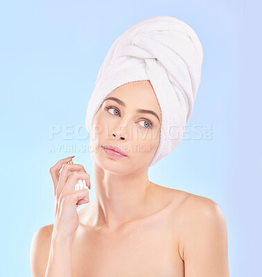 Buy stock photo Perfume, self care and young woman in a studio after a shower, health and wellness routine. Spray, beauty and female model from Australia with a clean skin treatment isolated by a blue background.