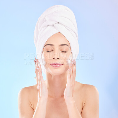 Buy stock photo Face, skincare and woman with soap, towel and isolated in studio on a blue background. Eyes closed, cosmetic and model washing, cleaning or hygiene with facial foam for health, dermatology or beauty