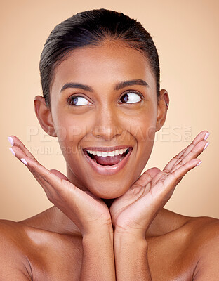 Buy stock photo Thinking, beauty or happy woman with natural facial glow with dermatology skincare cosmetics in studio. Hands, background or face of Indian girl model smiling with health ideas, wellness or self love