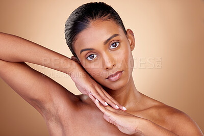 Buy stock photo Beauty, portrait and indian girl for skincare with hands in brown studio background. Dermatology, face and spa treatment with self care or natural cosmetics in mock up for luxury facial or wellness.