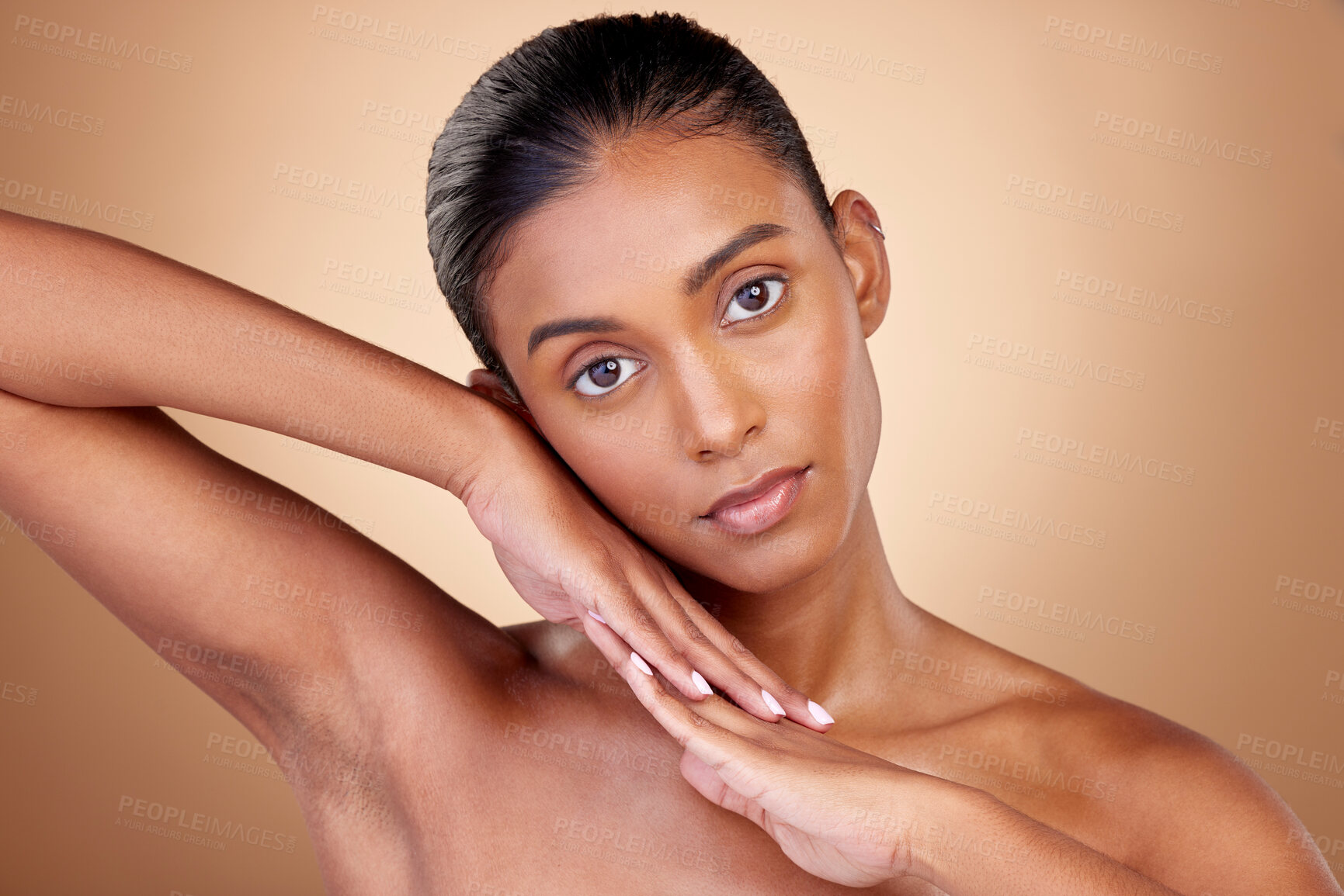 Buy stock photo Beauty, portrait and indian girl for skincare with hands in brown studio background. Dermatology, face and spa treatment with self care or natural cosmetics in mock up for luxury facial or wellness.