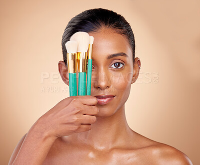 Buy stock photo Beauty, makeup and brush with portrait of woman in studio for facial, foundation and self care. Cosmetics, product and tools with face of model on brown background for glow, skincare and dermatology