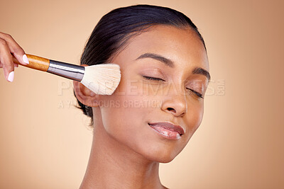 Buy stock photo Beauty, makeup and relax with woman and brush in studio for facial, foundation and self care. Cosmetics, product and tools with face of model on brown background for glow, skincare and dermatology