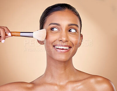 Buy stock photo Beauty, makeup and smile with woman and brush in studio for facial, foundation and self care. Cosmetics, product and tools with face of model on brown background for glow, skincare and dermatology