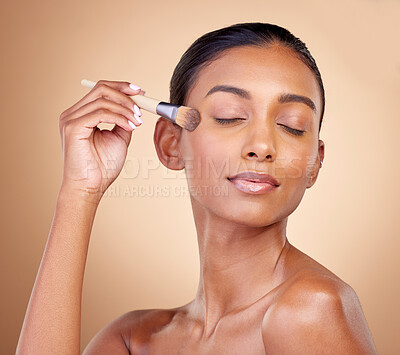 Buy stock photo Beauty, makeup and skincare with woman and brush in studio for facial, foundation and self care. Cosmetics, product and tools with face of model on brown background for glow, relax and dermatology