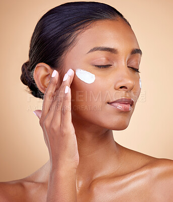 Buy stock photo Face, cream and woman with eyes closed for skincare cosmetics, dermatology or aesthetic makeup on studio background. Indian female model, lotion and facial sunscreen for clean beauty, glow and shine 