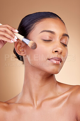 Buy stock photo Beauty, makeup and product with woman and brush in studio for facial, foundation and self care. Cosmetics, spa and tools with face of model on brown background for glow, skincare and dermatology