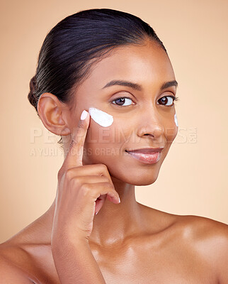 Buy stock photo Face, beauty and woman, cream and cosmetics with skincare product on studio background. Indian female model in portrait, healthy glow and lotion on skin, dermatology and moisturizer with facial
