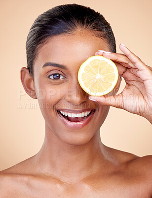 Buy stock photo Lemon, beauty and portrait of happy woman in studio for vitamin c nutrition, spa or natural cosmetics. Face of indian female model, healthy skincare or citrus fruit in dermatology, vegan diet or glow