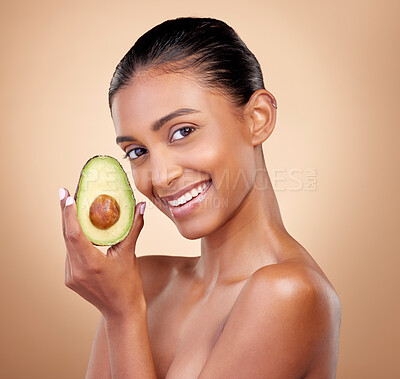 Buy stock photo Avocado, beauty and portrait of happy woman in studio, background and aesthetic glow. Face of indian model, natural skincare and fruit for sustainable cosmetics, vegan dermatology and facial benefits