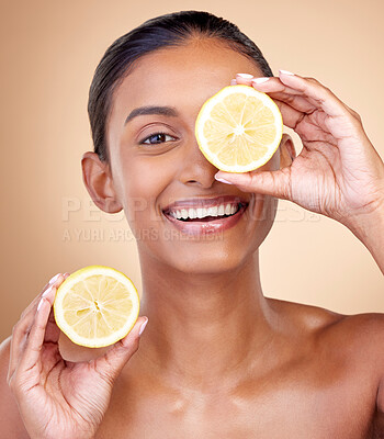 Buy stock photo Lemon fruit, portrait and skincare of woman in studio for vitamin c benefits, eco cosmetics or nutrition. Face of indian female model, natural beauty and healthy citrus food for aesthetic dermatology