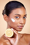 Woman, portrait and cream with lemon for skincare, cosmetics cleaning and natural beauty product or vitamin c benefits. Face of young person with fruits for dermatology on studio, brown background