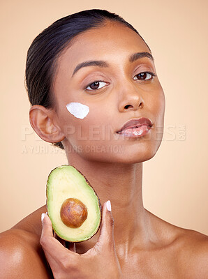 Buy stock photo Avocado, cream and skincare with portrait of woman in studio for product, beauty and natural cosmetics. Spa, facial and lotion with face of model on brown background for vitamin c and self care