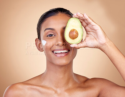Buy stock photo Avocado, cream and beauty with portrait of woman in studio for product, skincare and natural cosmetics. Spa, facial and lotion with face of model on brown background for vitamin c and self care