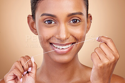 Buy stock photo Woman, dental floss and studio portrait with smile, cleaning and teeth whitening by brown background. Girl, model and happy with dentistry product, string or self care for cosmetics, beauty or health