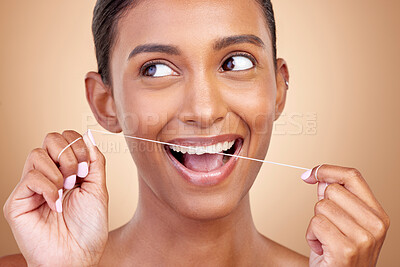 Buy stock photo Woman, dental floss and studio for thinking, smile and cleaning for teeth whitening by brown background. Girl, model or happy for dentistry product, ideas or self care for cosmetic, beauty or health