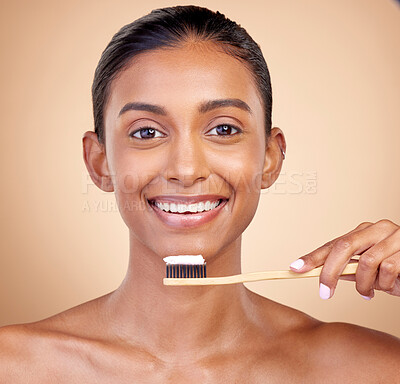 Buy stock photo Woman, wood toothbrush and studio portrait for smile, cleaning and teeth whitening by brown background. Girl, model and happy with bamboo dentistry product, self care and cosmetic beauty with health