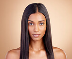 Portrait, hair care and Indian woman with beauty, cosmetics and texture on a brown studio background. Face, female person and model with volume, shine and scalp treatment with aesthetic and skincare