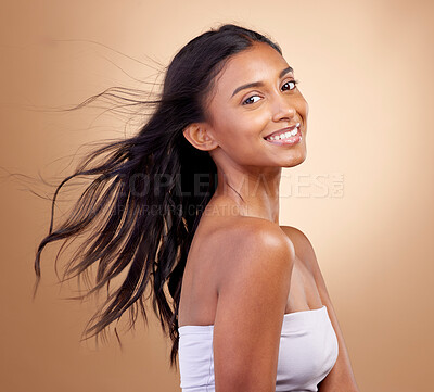 Buy stock photo Portrait, haircare and salon for indian woman with beauty in brown studio background with glow. Hairstyle, happy face and girl with shine or keratin treatment, volume and natural cosmetic in mockup.