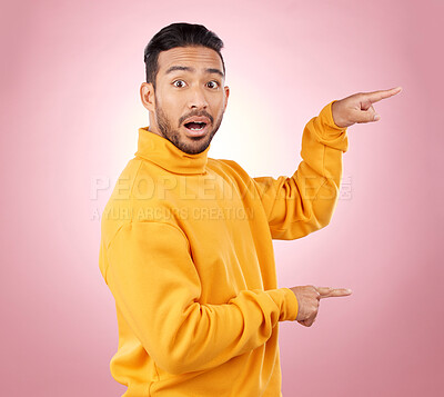 Buy stock photo Surprise, pointing and wow with portrait of man in studio for show, announcement and deal. News, advertising and idea with person on pink background for promotion, information and solution mockup