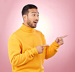 Surprise, pointing and wow with man and space in studio for show, announcement and deal. News, advertising and idea with person on pink background for promotion, information and solution mockup