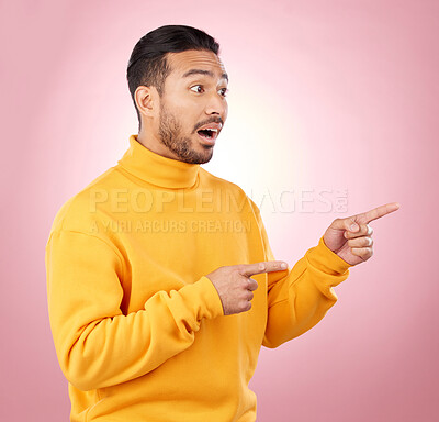 Buy stock photo Surprise, pointing and wow with man and space in studio for show, announcement and deal. News, advertising and idea with person on pink background for promotion, information and solution mockup