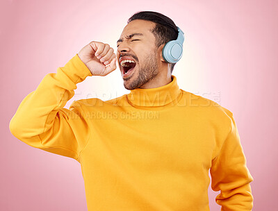 Buy stock photo Asian man, headphones and listening to music for karaoke or singing against a pink studio background. Happy male person enjoying online audio streaming, sound track or songs with headset on mockup