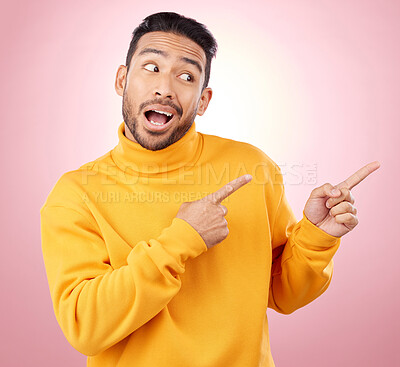 Buy stock photo Pointing finger, advertising and a man in studio with a wow announcement, promotion or decision. Face of male asian model with hands for marketing sale, news or presentation on a pink background