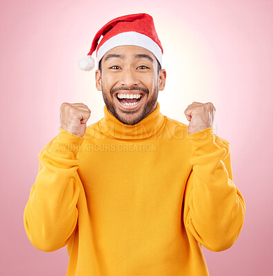 Buy stock photo Portrait, excited and smile, man with Christmas hat for fun and yes at festive holiday on pink background. Happy, winning celebration and model with santa cap and winter vacation success in studio.