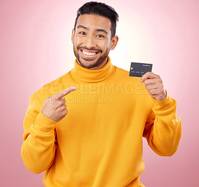 Buy stock photo Man, pointing and credit card with finance, payment and loan, budget and fashion sale on studio pink background. Portrait, banking and happy asian person or gen z with retail transaction or shopping