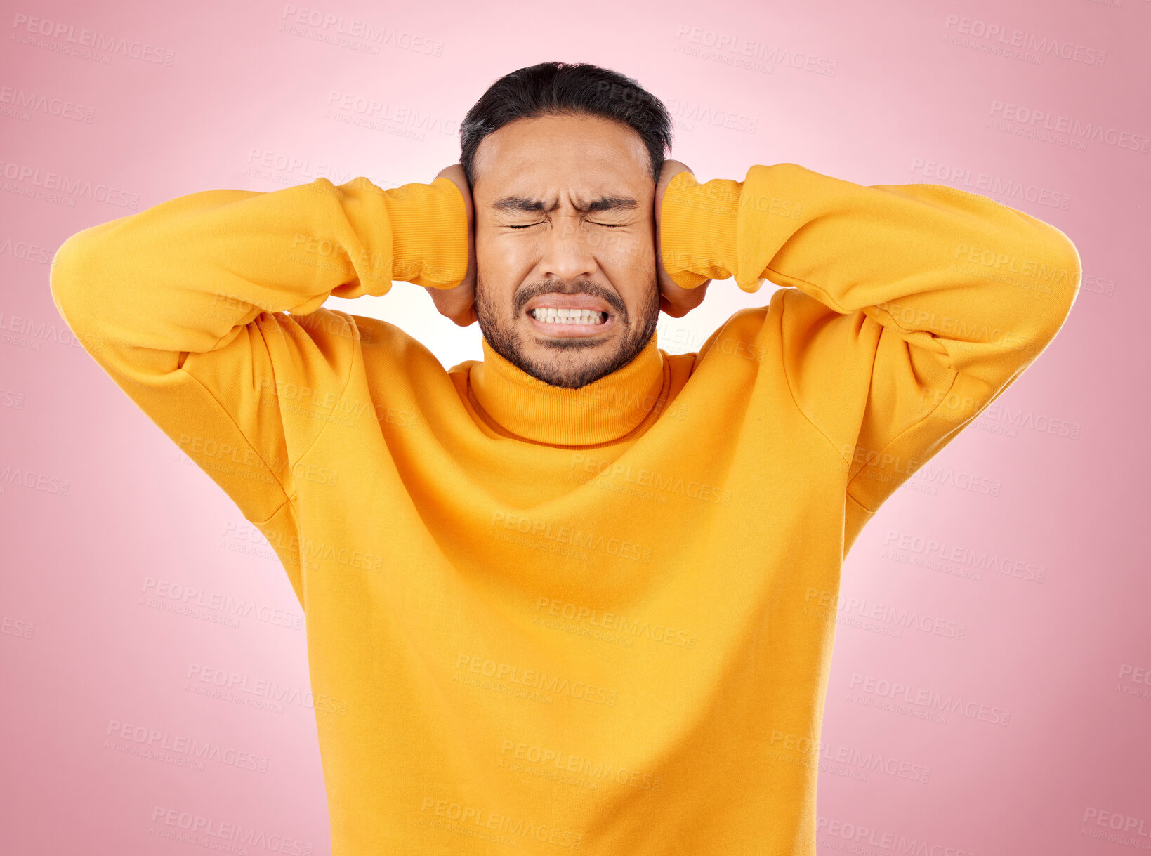 Buy stock photo Man, headache and cover ears for stress or mental health of student frustrated on a pink background. Angry, anxiety and fear or scared young person with hands to stop noise or sound in studio