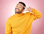 Happy, peace sign and portrait of man in studio for support, kindness and emoji. Smile, happiness and thank you with face of person on pink background for mindfulness, vote and v hand gesture