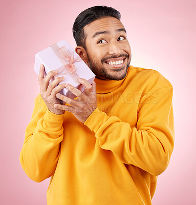 Buy stock photo Man, winner and gift box, birthday celebration and prize, excited giveaway or shopping on pink background. Happy person thinking of present, ribbon package and retail sale or competition in studio