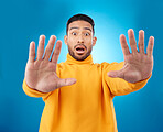 Stop, hands and portrait of asian man in studio with wow, news and wait sign on blue background. Face, palm and Japanese male model shocked by surprise deal, coming soon or sale promotion or info