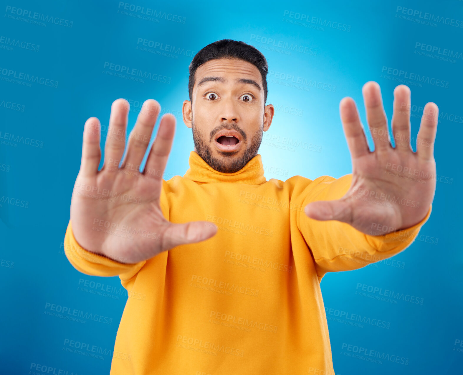 Buy stock photo Stop, hands and portrait of asian man in studio with warning, danger and wait sign on blue background. Face, palm and Japanese male model with caution, fear of surprise, drama or block conflict 
