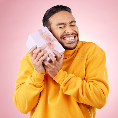 Buy stock photo Man, excited winner and gift box, birthday celebration and prize, giveaway or shopping on pink background. Happy person with present, ribbon package and retail sale or competition love in studio