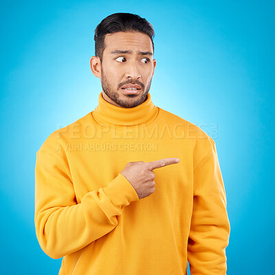 Buy stock photo Wtf, surprise and asian man hand pointing in studio for menu, questions and how to steps on blue background. Omg, doubt and male face with finger show feedback, schedule or presentation with anxiety