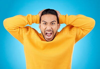Buy stock photo Angry, man and portrait with screaming in studio with burnout, anxiety and stress. Mental health, blue background and frustrated male person with yelling with anger about problem, mistake and issue