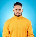 Face, asian man and holding breath in studio for suspense, promo or overwhelmed on blue background. Cheeks, air and waiting to breathe by Japanese male with countdown, nervous or uncertain emoji