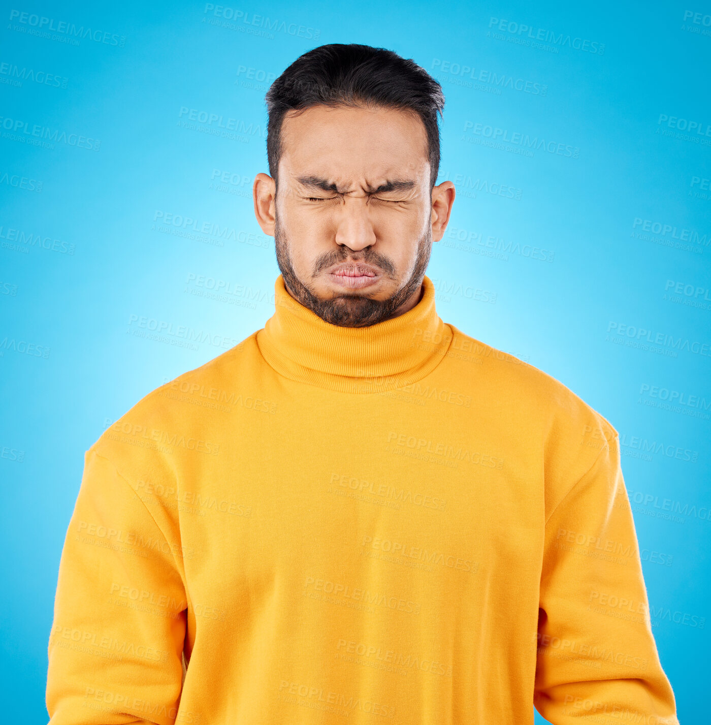 Buy stock photo Face, asian man and holding breath in studio for suspense, fear or stress on blue background. Puff cheeks, air and waiting to breathe by funny male person with countdown, nervous or uncertain emoji